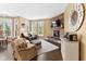 Comfortable living room with a stone fireplace, plush seating, and large windows at 13214 Mink Ln, Carmel, IN 46074