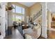 Open-concept living room boasting soaring ceilings, fireplace, and stylish staircase at 13214 Mink Ln, Carmel, IN 46074