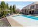 Sparkling pool with patio furniture and lush landscaping creates a backyard oasis at 13214 Mink Ln, Carmel, IN 46074