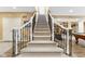 Elegant staircase with carpeted steps and decorative iron railing at 13214 Mink Ln, Carmel, IN 46074