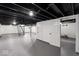 Spacious basement with painted floor and exposed ceiling, featuring storage space at 1331 W 33Rd St, Indianapolis, IN 46208