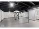 Unfinished basement with painted walls and ceiling, utility components, and stairs leading to the upper level at 1331 W 33Rd St, Indianapolis, IN 46208