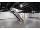 Spacious basement with painted floor and exposed ceiling, stairs in view at 1331 W 33Rd St, Indianapolis, IN 46208