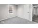 Bedroom featuring one window, gray carpet and a partial view of the hallway outside of the room at 1331 W 33Rd St, Indianapolis, IN 46208