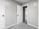Bedroom featuring a partial view of the hallway outside of the room, gray carpet and a window at 1331 W 33Rd St, Indianapolis, IN 46208