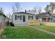Charming single-story home featuring a neat front yard, gray siding, a small porch, and black shutters at 1331 W 33Rd St, Indianapolis, IN 46208