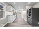 Modern kitchen featuring sleek white cabinets, gray countertops, stainless steel appliances, and laminate flooring at 1331 W 33Rd St, Indianapolis, IN 46208