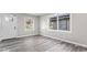 Living room showcasing gray flooring, fresh gray paint, abundant natural light and new white door at 1331 W 33Rd St, Indianapolis, IN 46208