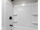 Bathroom shower/tub combo featuring a shower head and black fixtures, along with built in shelving at 1331 W 33Rd St, Indianapolis, IN 46208