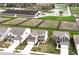 An aerial view showcases the home's location near equestrian facilities, paddocks, and some standing water, a creek, or low-lying area at 1455 Bigleaf Dr, Sheridan, IN 46069