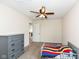 This bedroom has a grey dresser, carpet and a ceiling fan at 1455 Bigleaf Dr, Sheridan, IN 46069