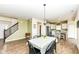 Open-concept living with dining table, chairs, and kitchen featuring stainless steel appliances and a breakfast bar at 1455 Bigleaf Dr, Sheridan, IN 46069