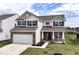 Beautiful two-story home with a manicured lawn, brick, and modern design at 1455 Bigleaf Dr, Sheridan, IN 46069