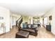 Inviting living room showcasing wood laminate floors, staircase, and seamless transition to the kitchen and dining area at 1455 Bigleaf Dr, Sheridan, IN 46069