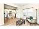 Cozy living room with view of kitchen, stainless appliances, island seating, and natural light at 1455 Bigleaf Dr, Sheridan, IN 46069