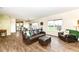 Open-concept living room flowing into the dining area and kitchen with views of the fenced backyard at 1455 Bigleaf Dr, Sheridan, IN 46069