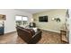 Cozy living room with hardwood floors, a large window, and an entertainment center with a wall-mounted TV at 1455 Bigleaf Dr, Sheridan, IN 46069