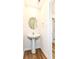 Small powder room with pedestal sink, round mirror, and tiled floors at 1455 Bigleaf Dr, Sheridan, IN 46069