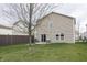 This backyard features a grassy lawn, fence, and patio area at 15398 Border Dr, Noblesville, IN 46060