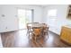 Cozy dining area featuring wood laminate floors and a charming wooden table set at 15398 Border Dr, Noblesville, IN 46060