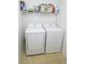 Convenient laundry room complete with appliances and overhead shelving at 15398 Border Dr, Noblesville, IN 46060