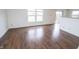 Well-lit living room featuring laminate floors and view of sliding glass doors at 15398 Border Dr, Noblesville, IN 46060