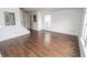 Bright living room featuring laminate floors and natural light from a large window at 15398 Border Dr, Noblesville, IN 46060