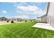 Backyard of home featuring freshly laid sod, a concrete patio and view of neighboring homes at 159 Derringer Ave, Westfield, IN 46074