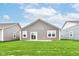 Home's backyard featuring sod, gray siding, and sliding glass door at 159 Derringer Ave, Westfield, IN 46074