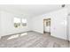 A carpeted bedroom with large windows and a view into the attached bathroom at 159 Derringer Ave, Westfield, IN 46074