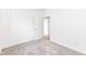 Bright bedroom featuring neutral gray carpet, white trim, and open door to another room at 159 Derringer Ave, Westfield, IN 46074