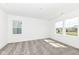 A carpeted bedroom with two large windows offering an abundance of natural light at 159 Derringer Ave, Westfield, IN 46074