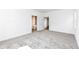 A carpeted bedroom with large windows and a view into the attached bathroom and closet at 159 Derringer Ave, Westfield, IN 46074