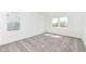 A carpeted bedroom with two large windows offering an abundance of natural light at 159 Derringer Ave, Westfield, IN 46074