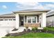 Inviting front porch with brick accents, gray siding, and manicured landscaping for a welcoming entrance at 159 Derringer Ave, Westfield, IN 46074
