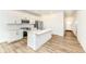 Bright kitchen featuring white cabinets, stainless steel appliances, a central island, and stylish flooring at 159 Derringer Ave, Westfield, IN 46074