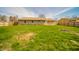 View of backyard with green lawn, fence and exterior building, great for entertaining at 1611 Orchard Ln, Anderson, IN 46011