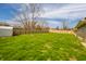 Large backyard with a green lawn, privacy fence, and space for outdoor activities at 1611 Orchard Ln, Anderson, IN 46011