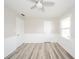 Bright bedroom featuring a modern ceiling fan, hardwood flooring, and ample natural light at 1611 Orchard Ln, Anderson, IN 46011