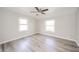 Bedroom features two windows and modern ceiling fan at 1611 Orchard Ln, Anderson, IN 46011