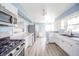 Bright kitchen with white cabinets, stainless steel appliances, and new granite countertops at 1611 Orchard Ln, Anderson, IN 46011