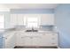 Bright kitchen features white cabinets and granite countertops at 1611 Orchard Ln, Anderson, IN 46011