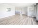 Bright living room with hardwood floors, light gray walls, and an open view to other rooms at 1611 Orchard Ln, Anderson, IN 46011