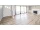Bright living room featuring hardwood floors, a fireplace, and large windows at 1611 Orchard Ln, Anderson, IN 46011