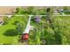 Inviting aerial view of house with spacious lawn, many trees, with multiple outbuildings and farmland in the background at 1901 S Old State Road 67, Paragon, IN 46166