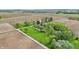 Expansive aerial view showcasing a well-maintained property with lush greenery, outbuildings, and surrounding farmland at 1901 S Old State Road 67, Paragon, IN 46166