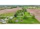 Rural farm setting of brick home amid green spaces and golden fields under a soft sky at 1901 S Old State Road 67, Paragon, IN 46166