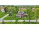 Stunning aerial view of a red brick home with mature trees and sprawling green lawns at 1901 S Old State Road 67, Paragon, IN 46166