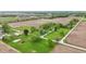Aerial view of a brick home settled in a tranquil landscape with expansive fields and greenery at 1901 S Old State Road 67, Paragon, IN 46166