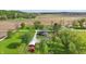 Lovely aerial view of home with well-manicured lawn, mature trees, farmland in the distance and additional outbuildings at 1901 S Old State Road 67, Paragon, IN 46166
